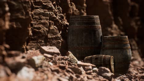 old-wooden-vintage-wine-barrels-near-stone-wall-in-canyon